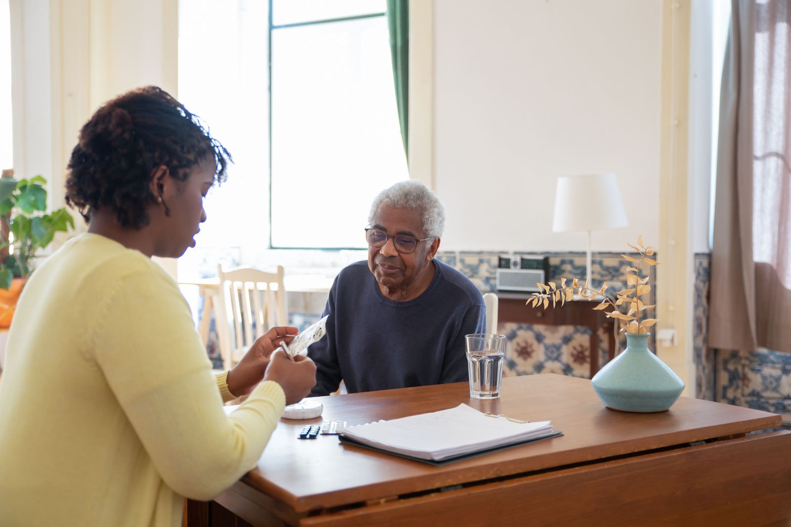 Caregiver warmly assisting person in wheelchair