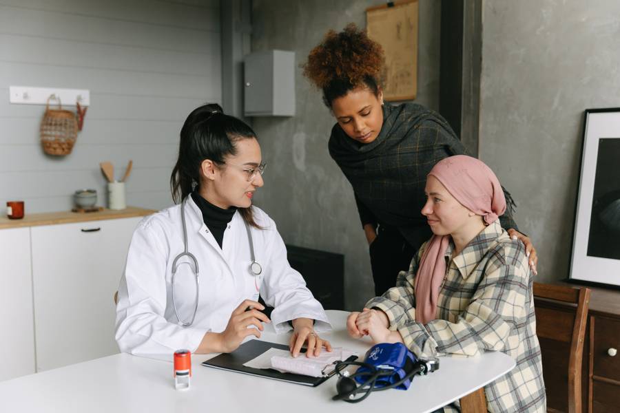Doctor going over care details with a patient and family member