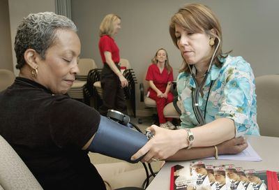 Senior woman doing balance exercises with physical therapist